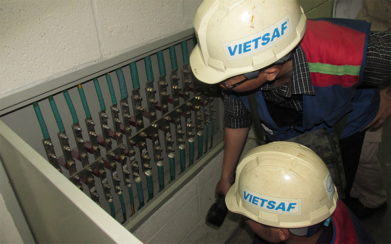 Kỹ thuật viên xem xét và đánh giá hộp kiểm tra tiếp địa trước khi đo điện trở nối đất